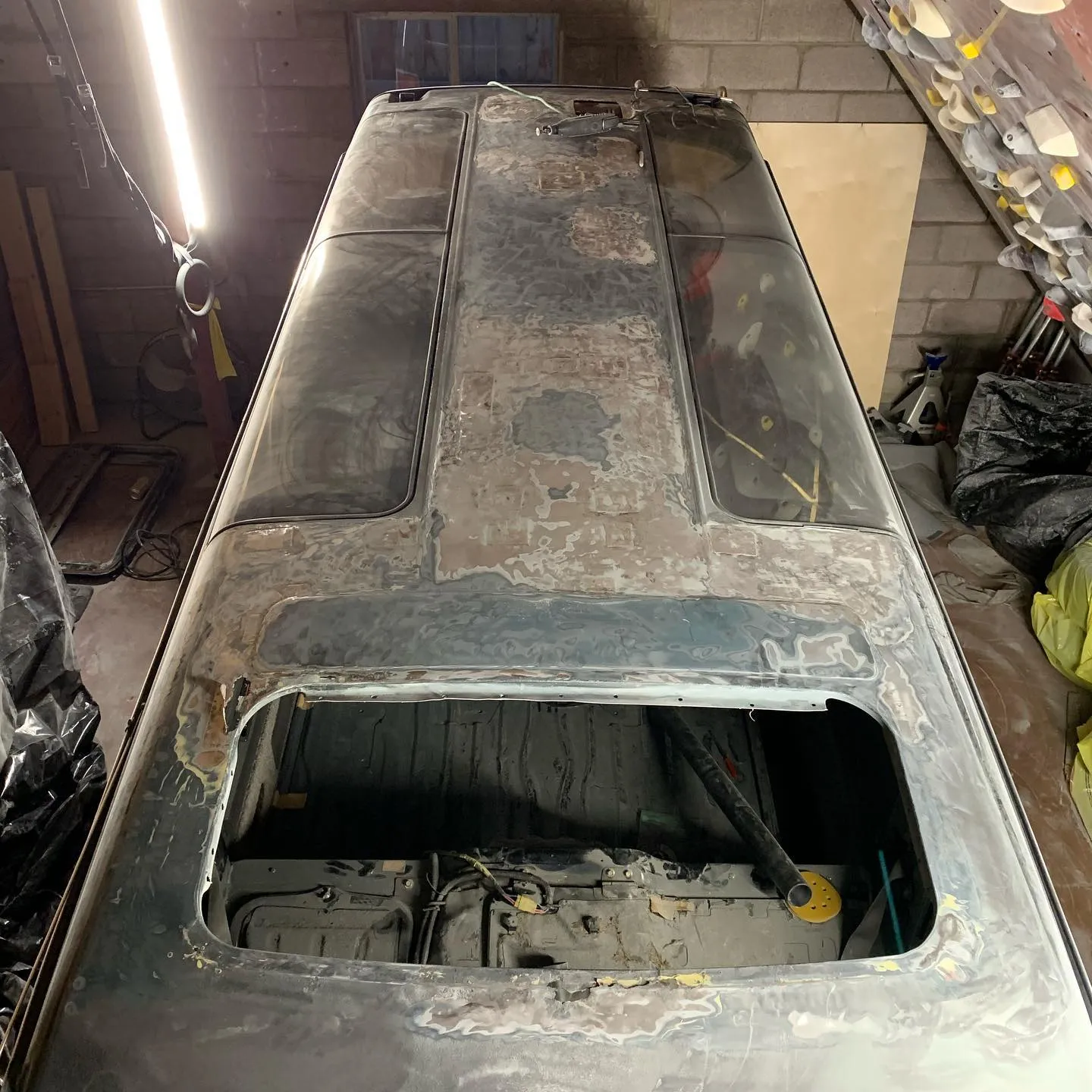 Excavating body filler to uncover holes in roof.